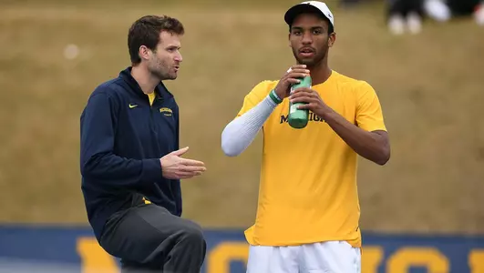 Marek Michalicka coaches a Michigan tennis athlete