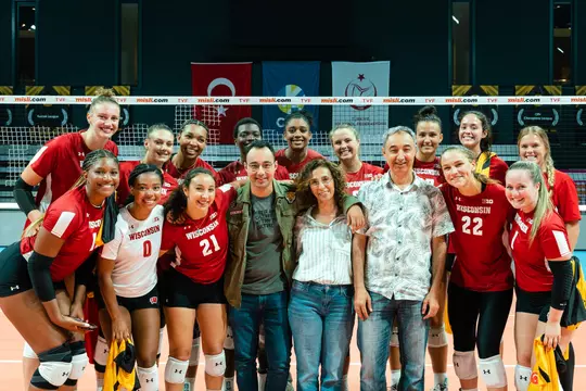 Gulce Guctekin and her Wisconsin volleyball teammates take a group photo together with the Guctekin family during the Badgers' 2023 European Tour