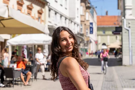Gulce Guctekin, Wisconsin volleyball, poses for a photo on a street during the Badgers' 2023 European Tour