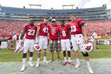 Captains Dare Ogunbowale, Vince Biegel, Sojourn Shelton and Bart Houston pose with honorary captain Mark Tauscher prior to the Wisconsin football game vs. LSU at Lambeau Field (Sept. 3, 2016)