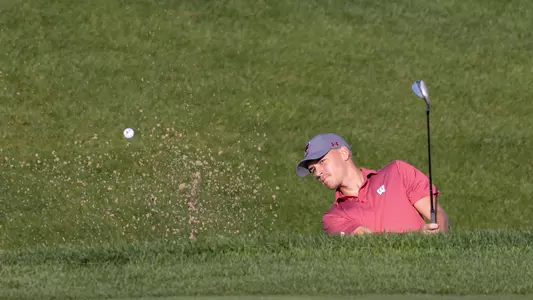 Daniel AAs, Wisconsin men's golf, chips the ball out of a bunker during the 2022 Badger Invitational at University Ridge Golf Course in Madison, Wisconsin.