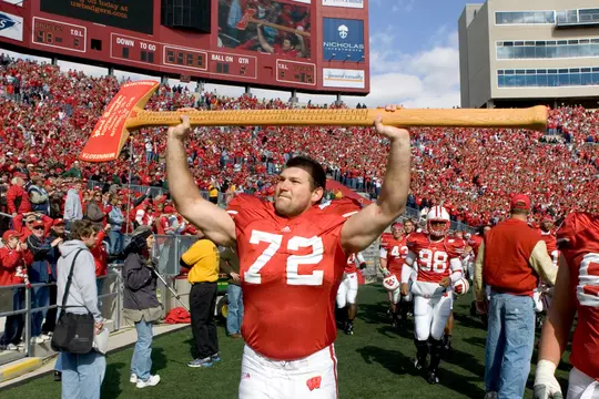 MADISON, WI - OCTOBER 14: Offensive lineman Joe Thomas #72 of the Wisconsin Badgers carries the Paul Bunyan Axe after beating the Minnesota Golden Gophers at Camp Randall Stadium on October 14, 2006 in Madison, Wisconsin. The Badgers beat the Golden Gophers 48-12. (Photo by David Stluka)