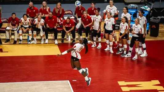 Temi Thomas-Ailara jump serves as the bench watches in the season opener against Baylor.