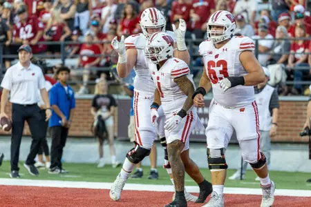 Wisconsin Badgers running back Chez Mellusi (1) celebrates a touchdown with teammates during an NCAA college football game against the Washington State Cougars, Saturday, Sept. 9, 2023, in Pullman, Wash. The Cougars won 31-22. (Photo by David Stluka/Wisconsin Athletic Communications)