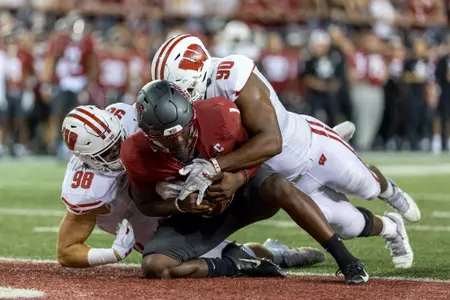 Wisconsin Badgers defensive lineman James Thompson Jr. (90) and linebacker C.J. Goetz (98) sack the quarterback during an NCAA college football game against the Washington State Cougars, Saturday, Sept. 9, 2023, in Pullman, Wash. The Cougars won 31-22. (Photo by David Stluka/Wisconsin Athletic Communications)