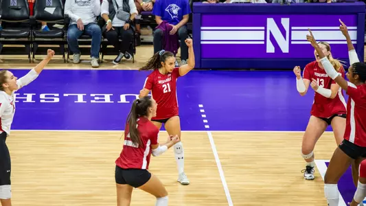 The Badgers celebrate after winning a point in match at Northwestern