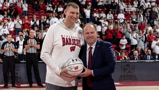 Brian Butch receives an honorary game ball during a Wisconsin men's basketball game