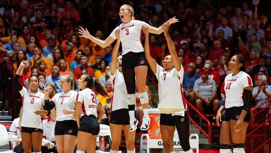 The Badger bench lifts up Saige Damrow in celebration