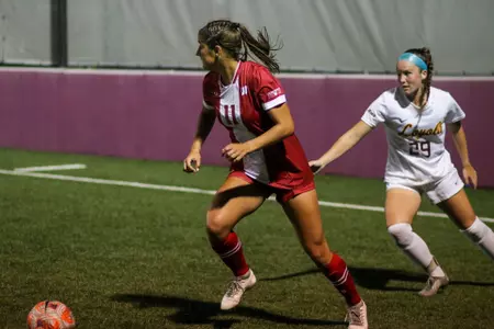 Riley Philbin dribbling against a Loyola defender