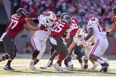 Wisconsin football defensive team rushes Washington State's quarterback on Saturday, Sept. 9, 2023 during NCAA Division I game in Pullman, Washington.