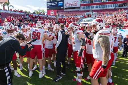 Wisconsin football head coach Luke Fickell in pre-game huddle with team prior to kickoff of 2024 ReliaQuest Bowl versus LSU at Raymond James Stadium in Tampa, Florida on Monday, January 1, 2024.