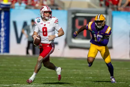Wisconsin quarterback Tanner Mordecai looks downfield with the ball during the NCAA football game against LSU for the 2024 ReliaQuest Bowl on Monday, January 1, 2024 in Tampa, Florida.