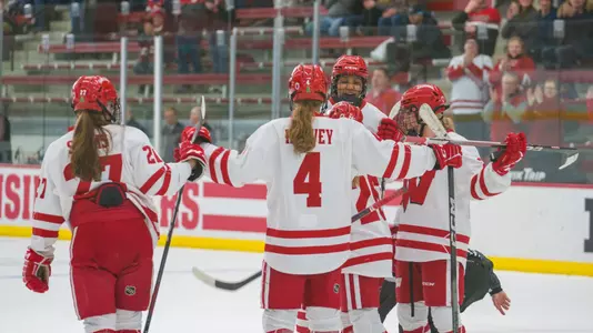The Wisconsin women's hockey team celebrates a goal against WCHA opponent, St. Thomas on Jan. 14, 2024 at LaBahn Arena