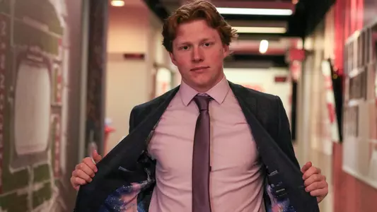 William Whitelaw walking into the locker room wearing a galaxy print suit.