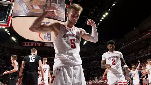 Tyler Wahl flexes and poses during a game against Michigan State