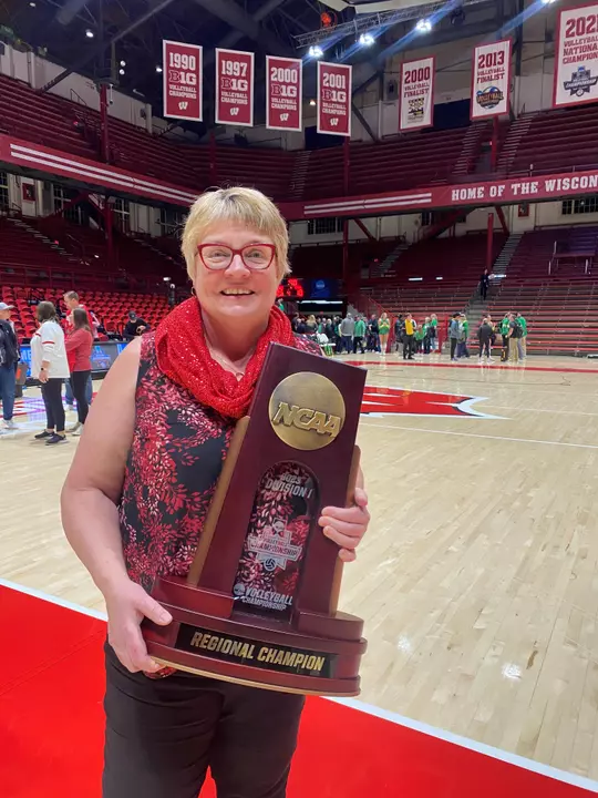 Diane Nordstrom with NCAA Volleyball 2023 Regional Trophy inside the UW Field House