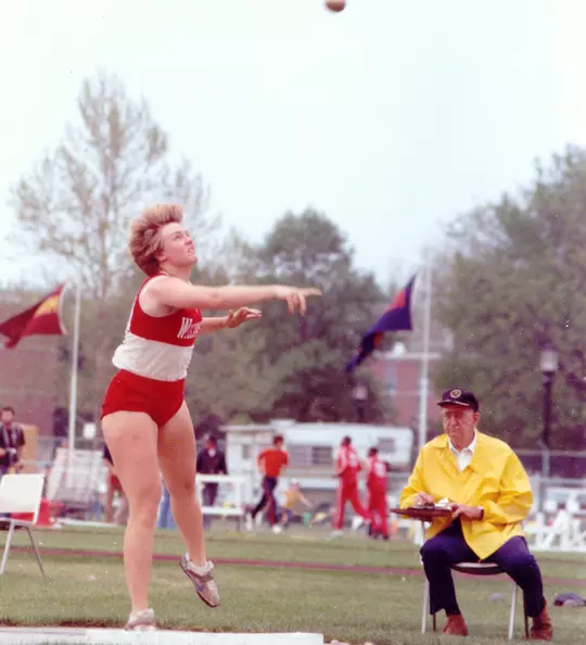 Diane Nordstrom throwing the shot put for Wisconsin Track & Field