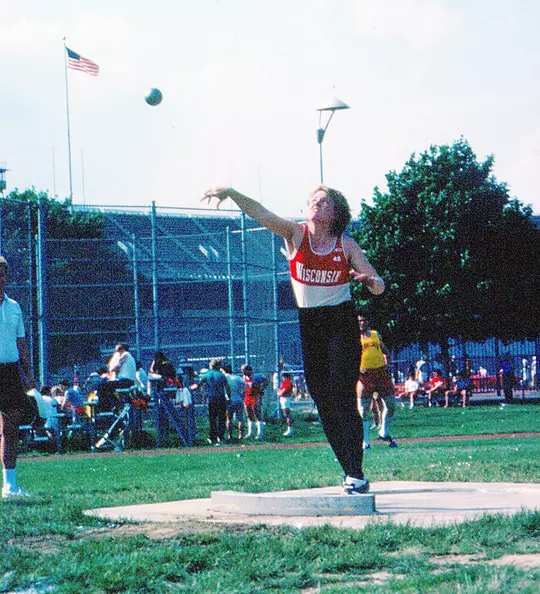 Diane Nordstrom throwing the shot put for Wisconsin Track & Field