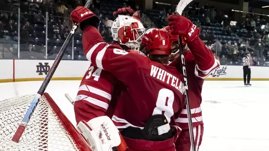 Members of the Wisconsin men's hockey team celebrate a win at Notre Dame.