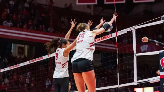 CC Crawford and Anna Smrek block the ball