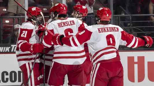 Wisconsin men's hockey team celebrates scoring a goal