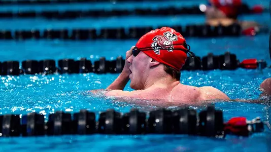 Badger swimmer looks at scoreboard after race
