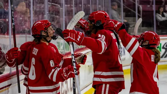 Lacey Eden celebrates a goal with Laila Edwards and teammates