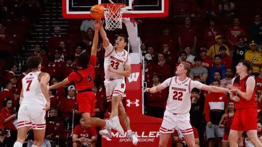 With Steven Crowl defending, Jack Janicki jumps for the layup