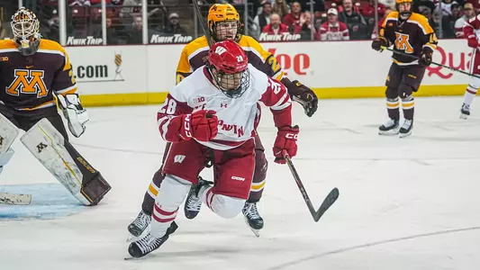 Adam Pietila hustles for the puck against Minnesota