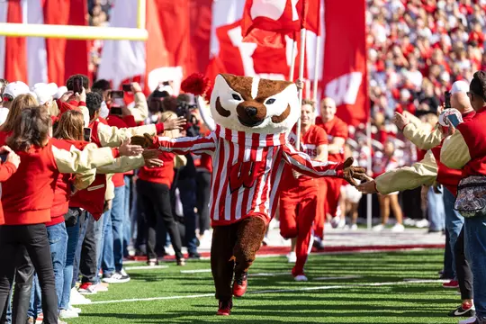 Wisconsin Badgers mascot Bucky Badger leads the team out of the tunnel.
