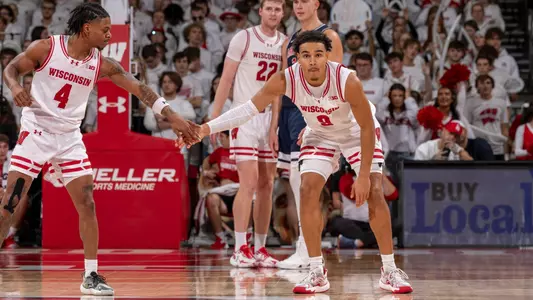 Kamari McGee gives a high-five to teammate John Tonje