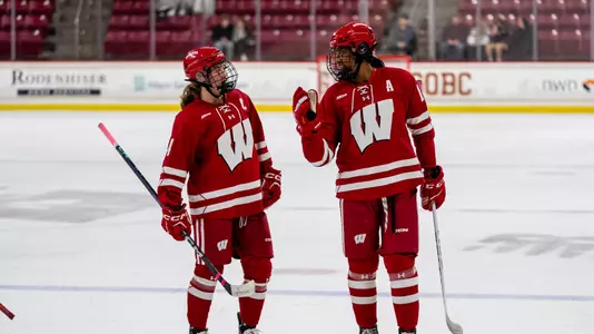 Laila Edwards and Caroline Harvey talk during a game