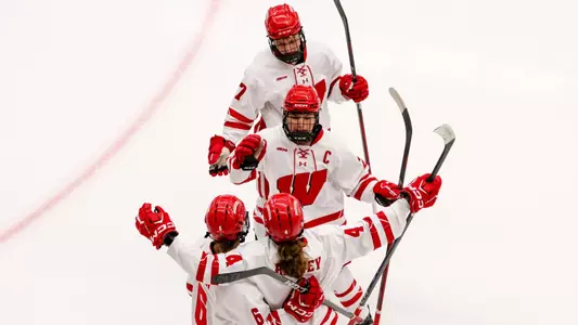Caroline Harvey, Casey O'Brien and the team celebrate a goal against St. Thomas