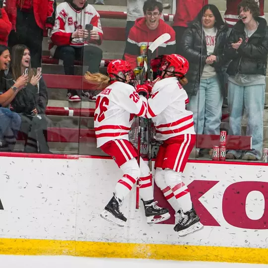 Caroline Harvey and Casey O'Brien celebrate a victory post-game against St. Thomas