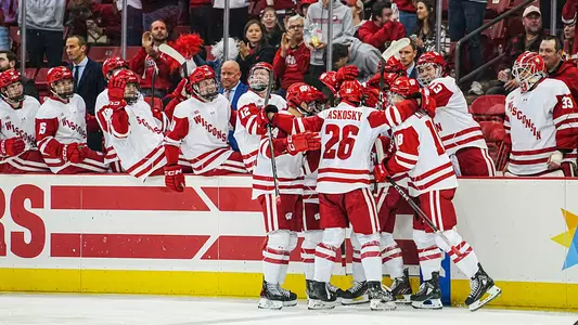 The Badger men's hockey team celebrates scoring a goal at the Kohl Center