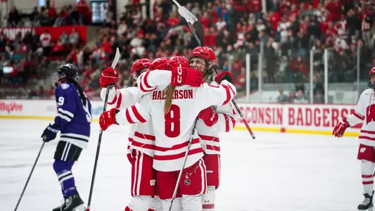 Hannah Halverson celebrates a goal with Badger teammates in a game against St. Thomas