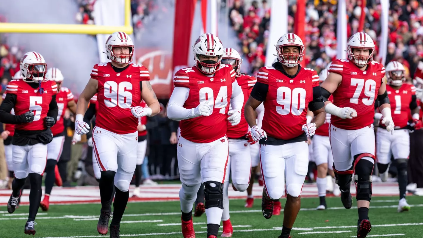 Wisconsin's Elijah Hills runs out of the tunnel for Friday's rivalry matchup with Minnesota