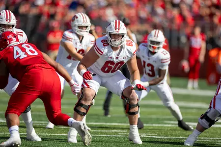 Wisconsin Badgers offensive lineman Joe Huber (60) blocks during a Big Ten Conference NCAA college football game against the Rutgers Scarlet Knights, Saturday, Oct. 12, 2024, in Piscataway, NJ. The Badgers won 42-7. (Photo by David Stluka/Wisconsin Athletic Communications)