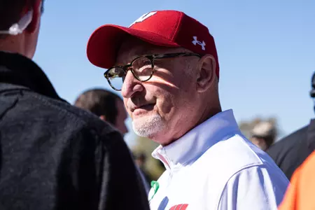Mick Byrne talks with reporters after the Big Ten Championships.