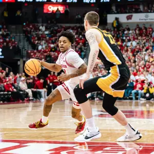 Kamari McGee drives against Iowa in 2023-24