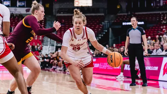 Natalie Leuzinger dribbles past Minnesota defender