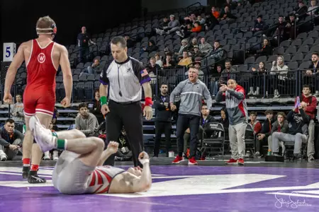 Shane Liegel celebrates winning 2023 Midlands Championships with coaches Bono and Reader cheering