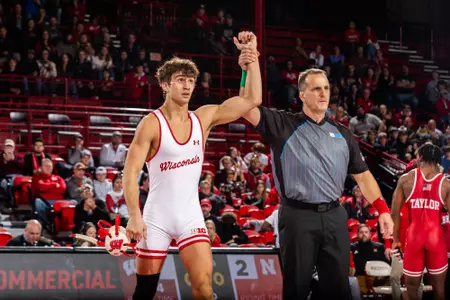 Dean Hamiti, Wisconsin wrestling, has his arm raised by the referee after earning a win in Wisconsin's dual match against Nebraska at the UW Field House.