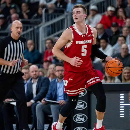 Tyler Wahl (5) dribbles up the court