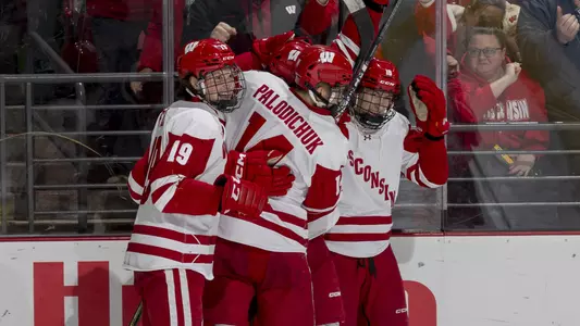 The Badger men's hockey team celebrates scoring a goal over Penn State.
