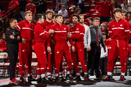 Felix Lettini and Wisconsin wrestling teammates Luke Mechler and Joe Zargo get ready to be announced for lineups during the Wisconsin versus Illinois dual match at the UW Field House on Sunday, Feb. 11, 2024.