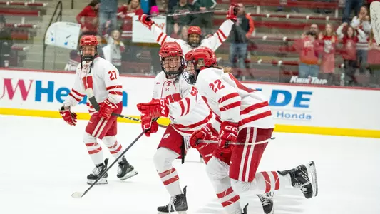 Members of the Wisconsin women's hockey team celebrate a goal from Laney Potter on Feb. 4, 2024 against SCSU