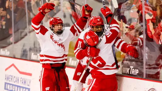 Members of the Wisconsin men's hockey team celebrate scoring a goal against Notre Dame.