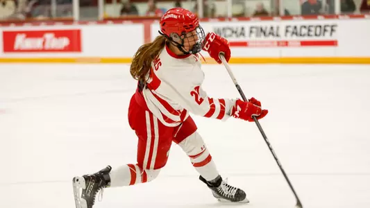 Kirsten Simms shoots a puck