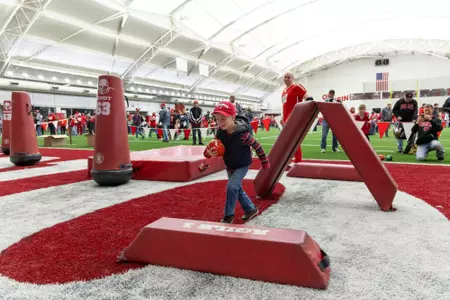 Young boy runs through an obstacle course at The Launch